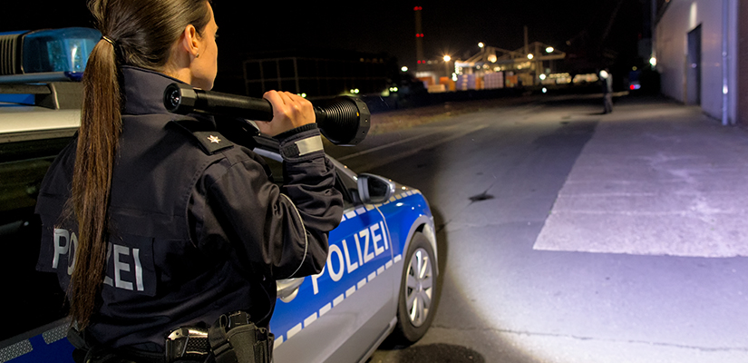 A police woman with a flashlight