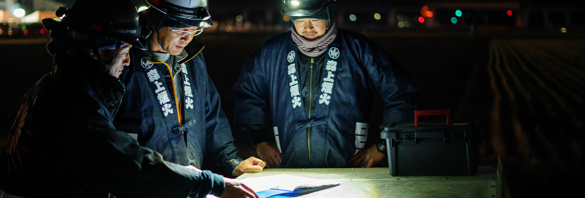 Three industry workers with headlamps