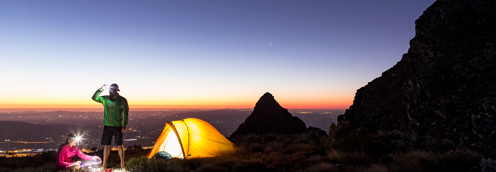 Two campers with headlamps