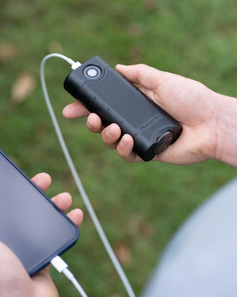 A smartphone is charging by a power bank