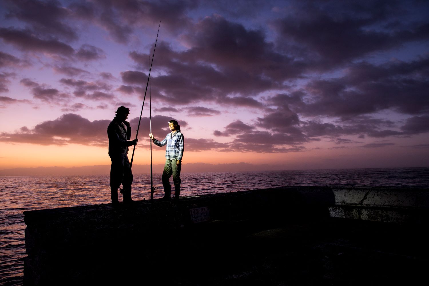 Two fishers with headlamps