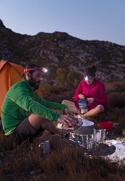 Two campers with headlamps
