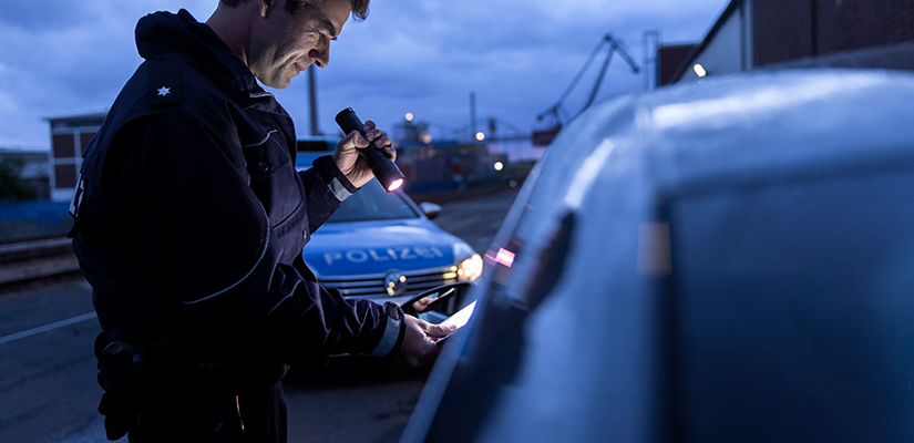 A police man with a flashlight