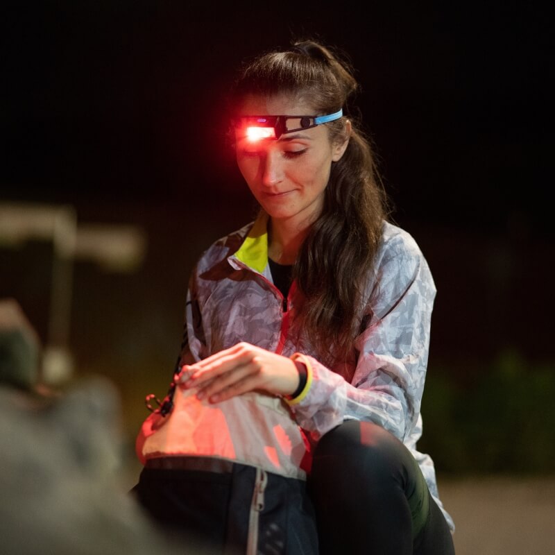 Woman with a red light headlamp