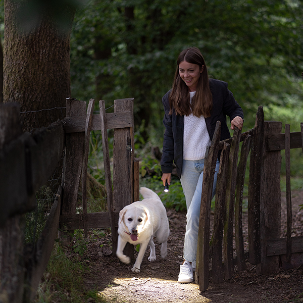 A woman taking her dog for a walk